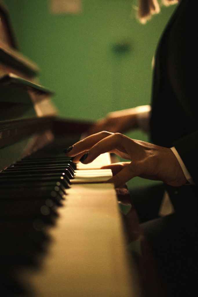 a close up shot of a pianist s hands while playing piano